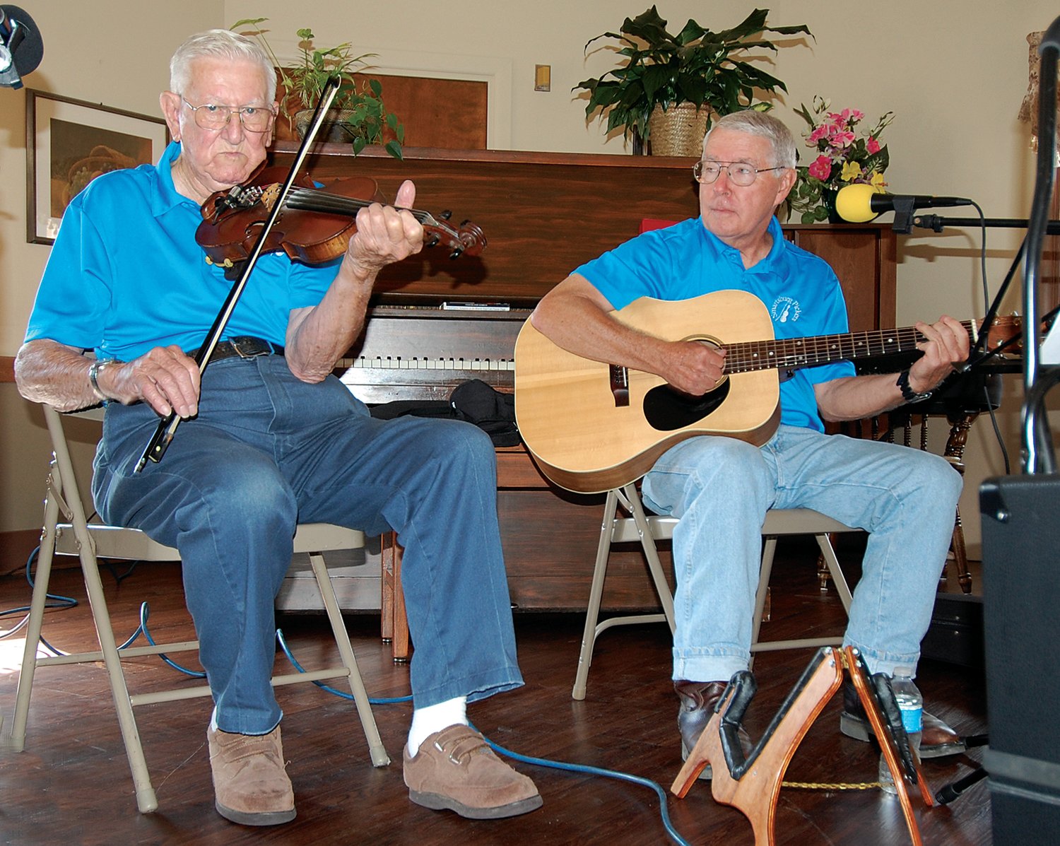 Archie Krout plays the fiddle while Alan Froedge plays the guitar during a 2014 performance of the Smartsburg Pickers at Williamsburg Healthcare.